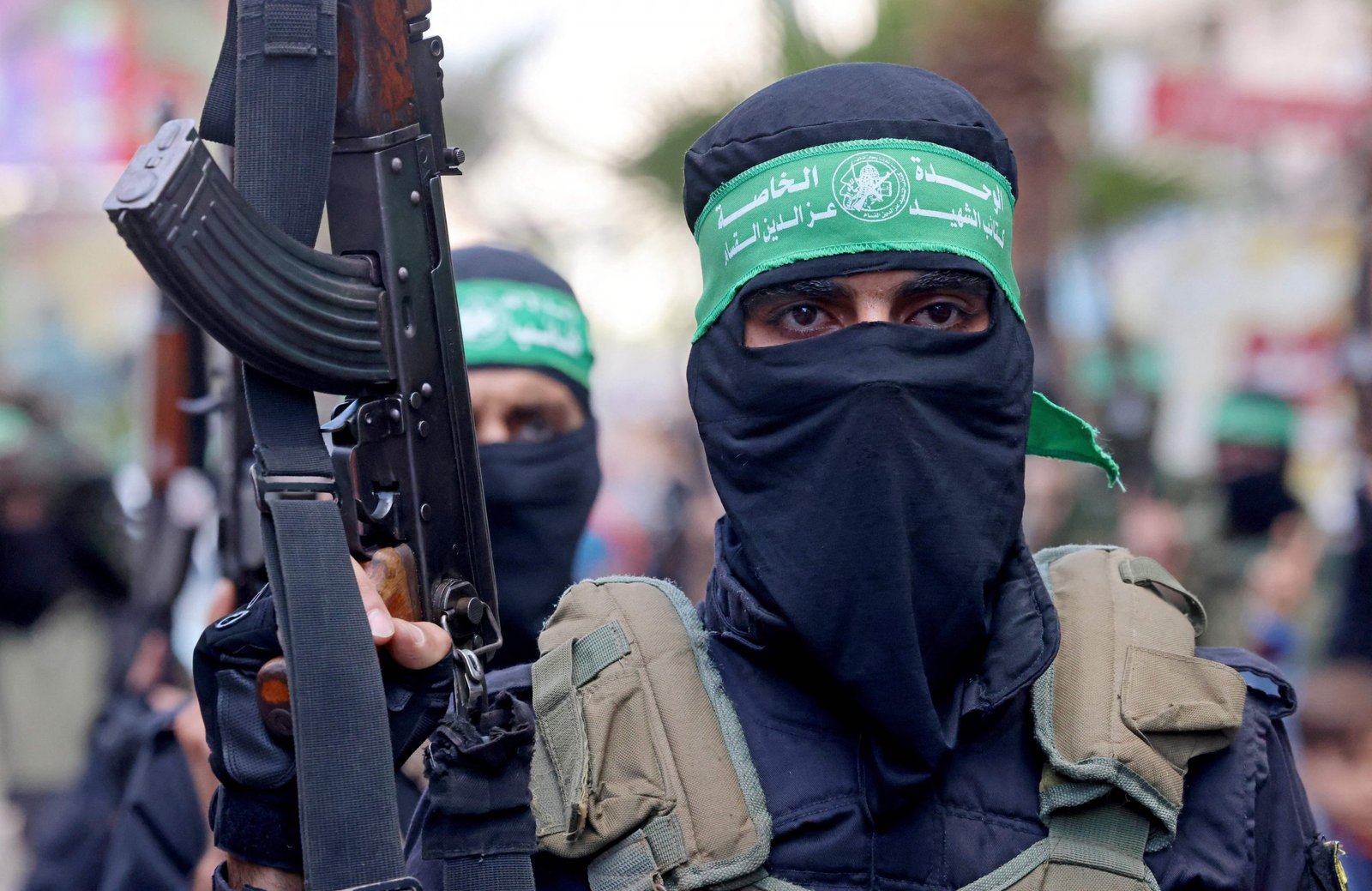 A picture of a resistance fighter with a green bandage and a gun