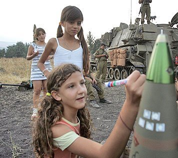 Israeli children writing on artillery shellings that will take innocents lives